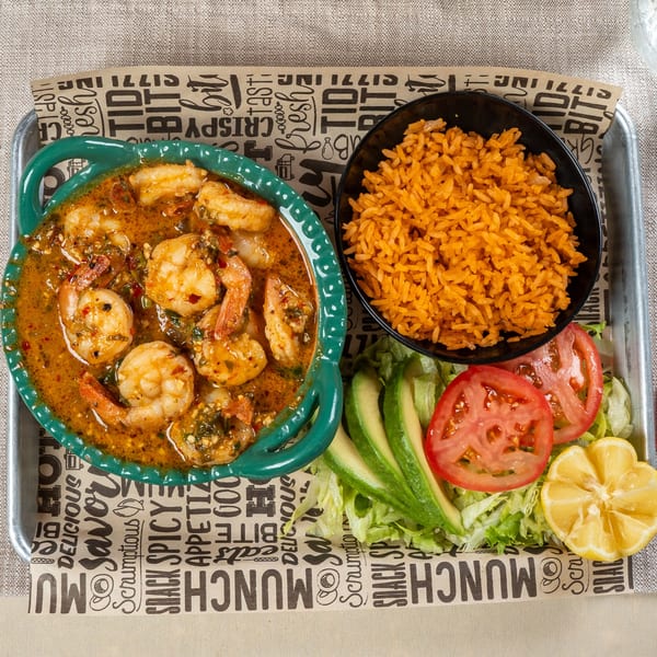 Chavela's Mexican Cuisine shrimp dish with red rice, lettuce, tomato, avocado, and lemon.